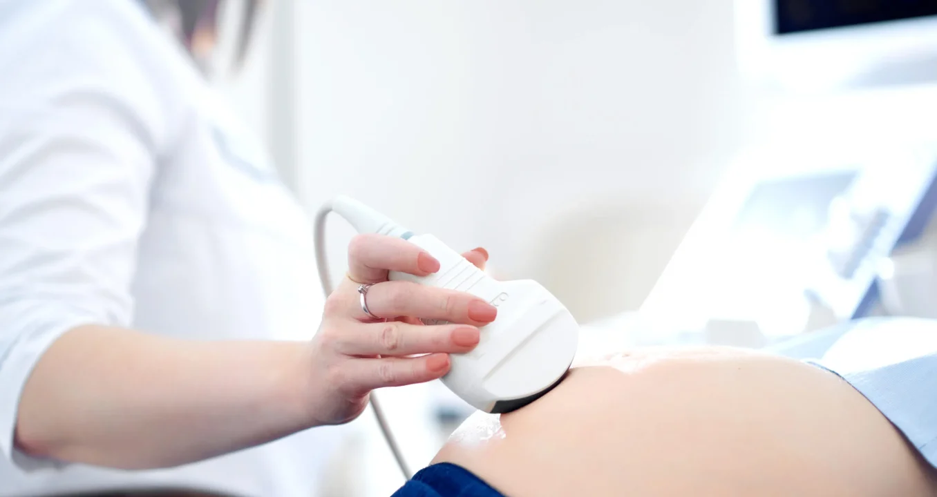 doctor-performing-ultrasound-scanning-her-pregnant-patient-scaled